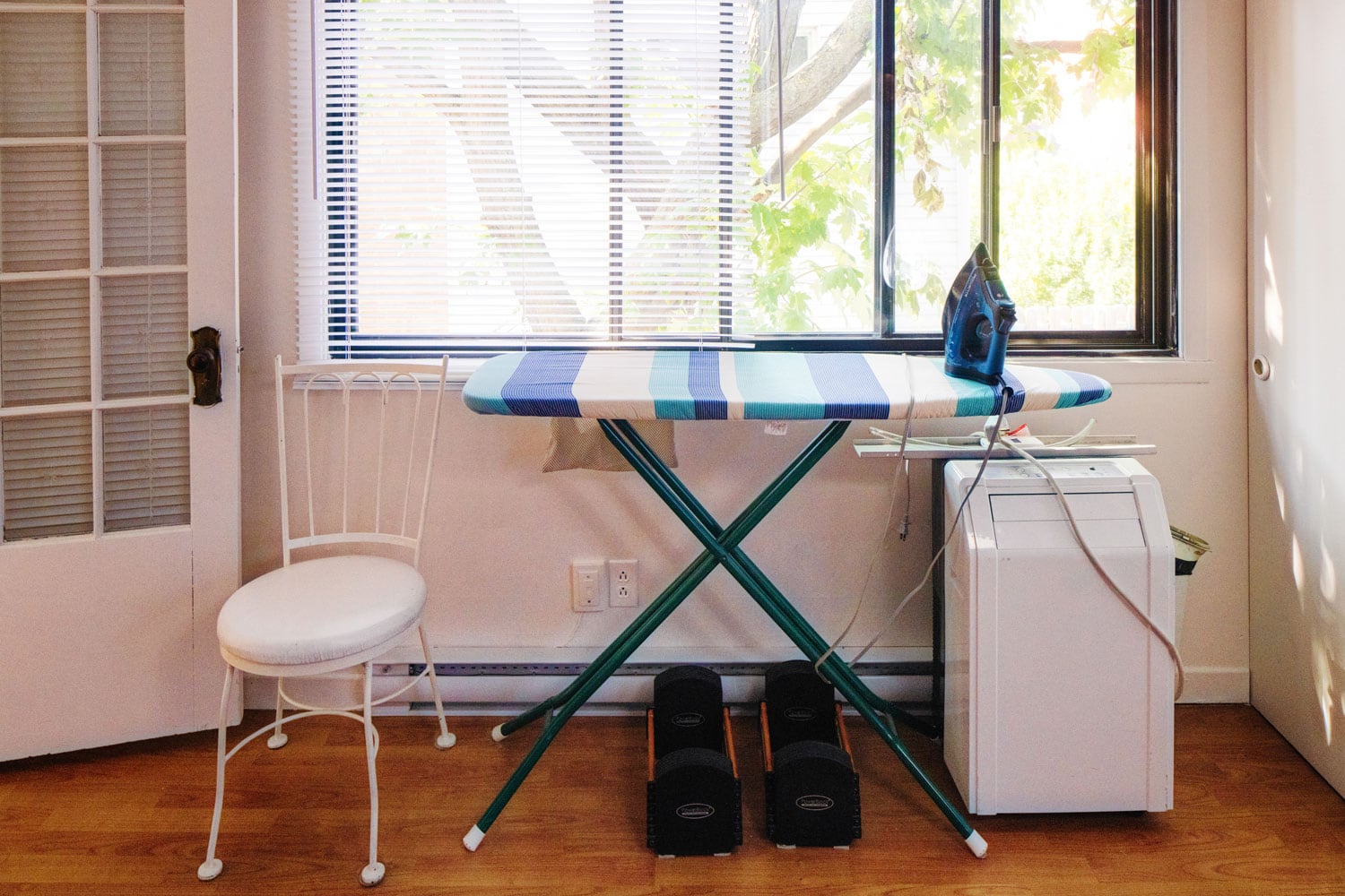 An ironing table and a portable air conditioning unit, How To Clean A Portable Air Conditioner [Including Coils And Water Tank]