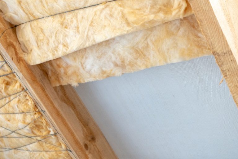 Batt insulation attached to the ceiling of a house, How Thick Is Batt Insulation? [By R-Value]