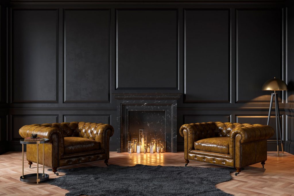 Black classic interior with fireplace, leather armchairs, carpet, candles