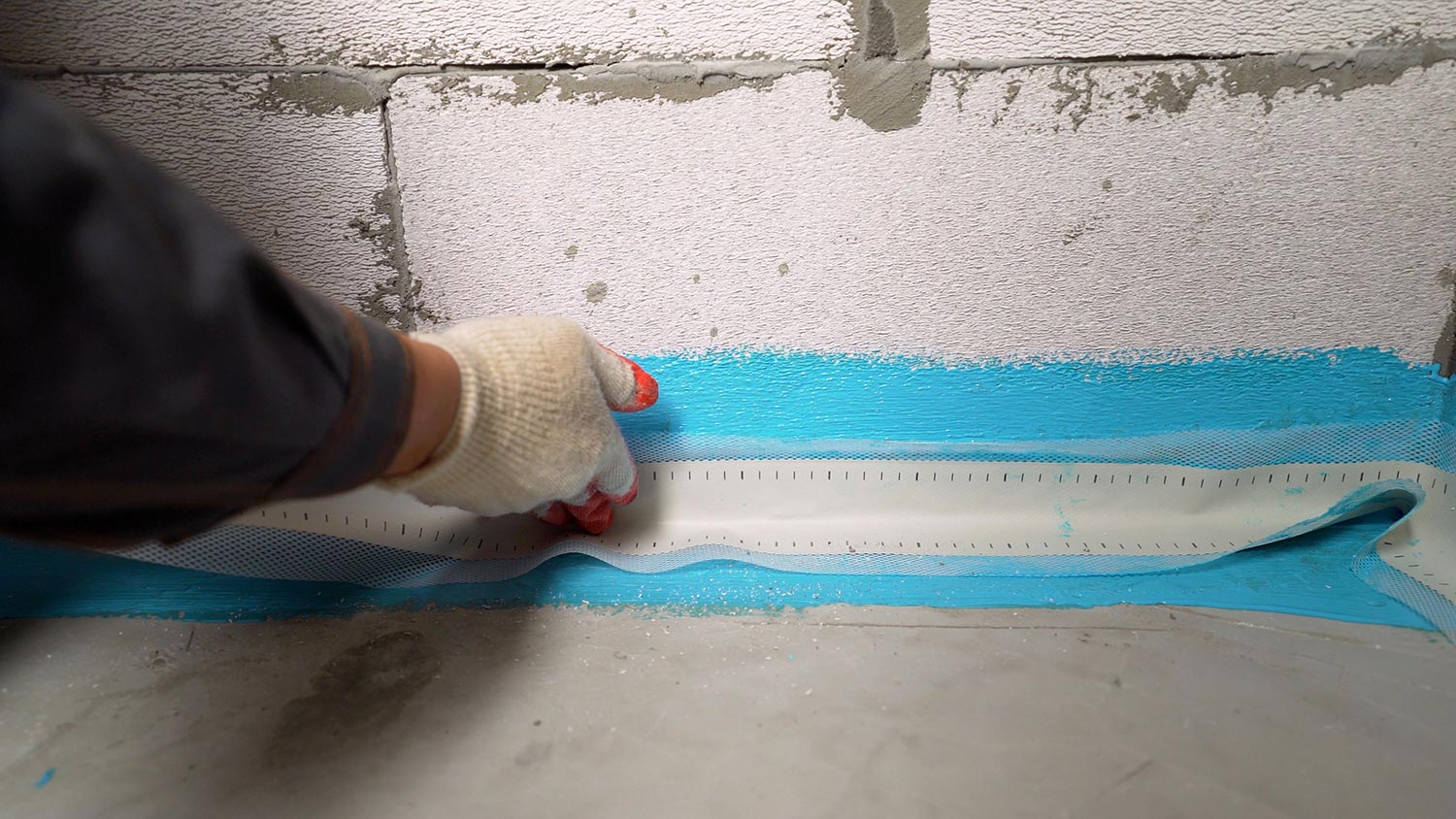 Bonding waterproofing tape to the floor