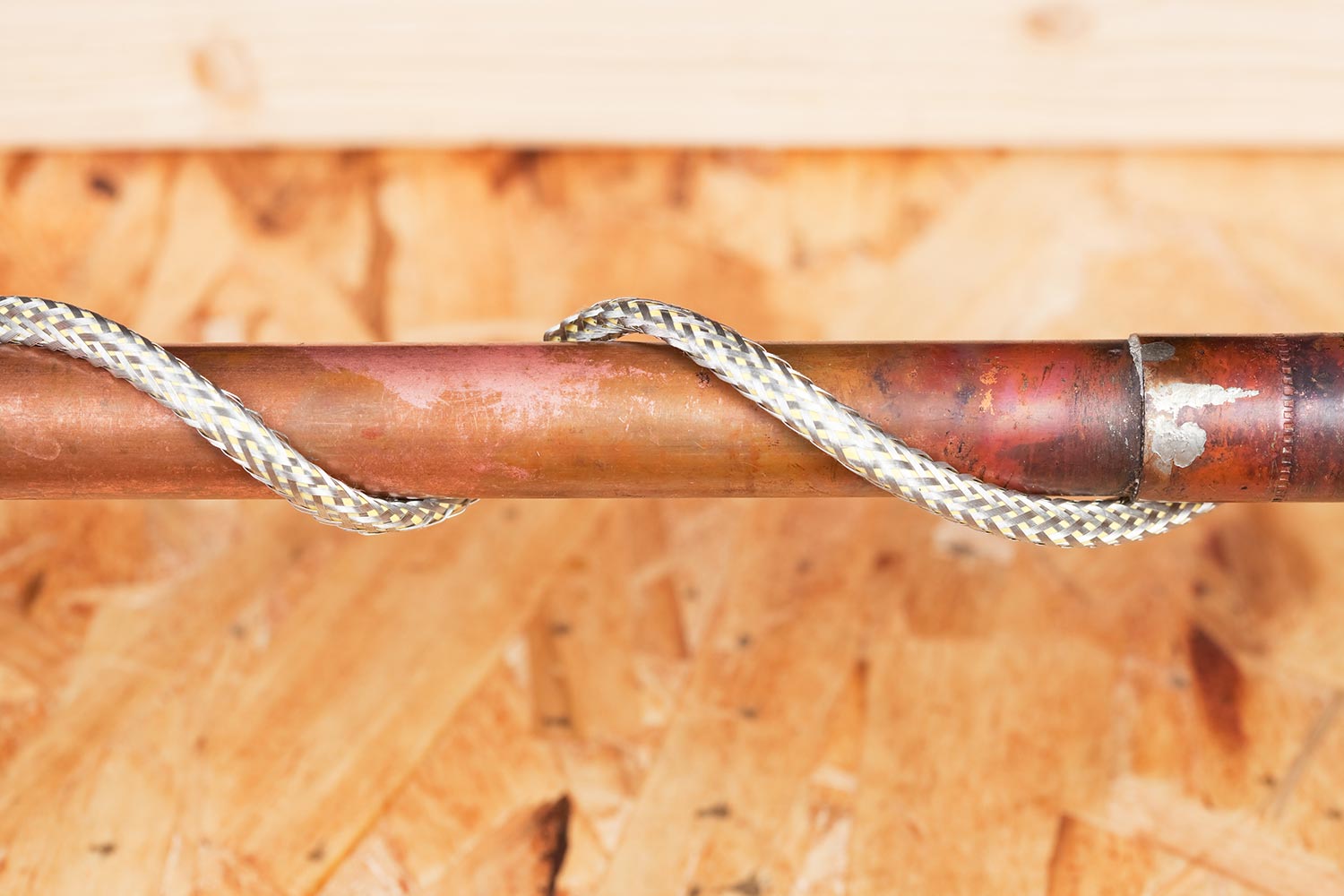 Copper water pipe wrapped with heating cord