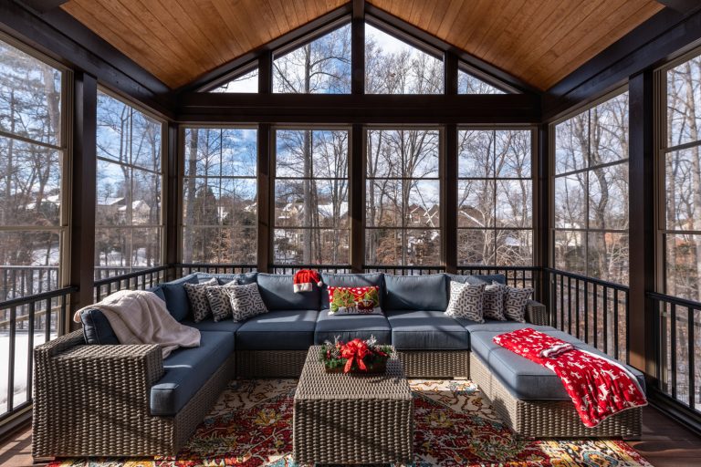 Cozy screened porch winter during Holidays season, snowy roofs and woods in the background - How To Insulate A Screened Porch For Winter