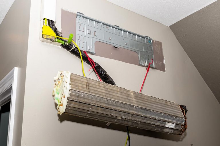 A ductless air conditioner system being remove from the wall for repair, How To Remove A Ductless Air Conditioner?