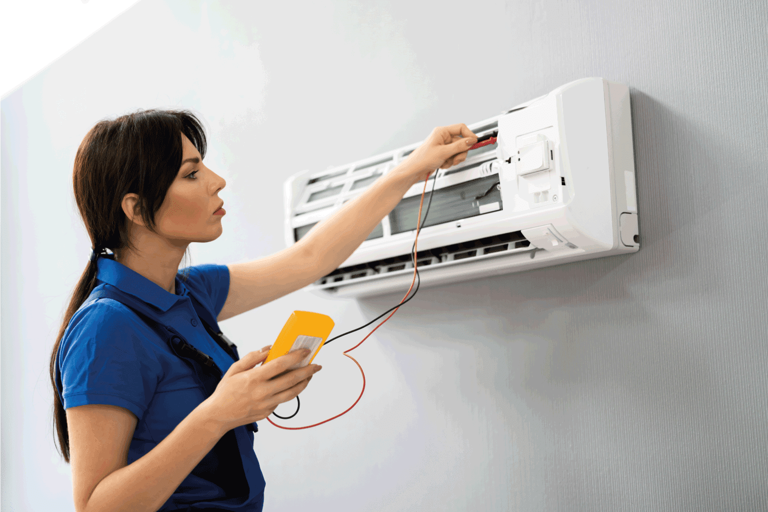 Electrician Repairing Air Conditioner. AC Maintenance