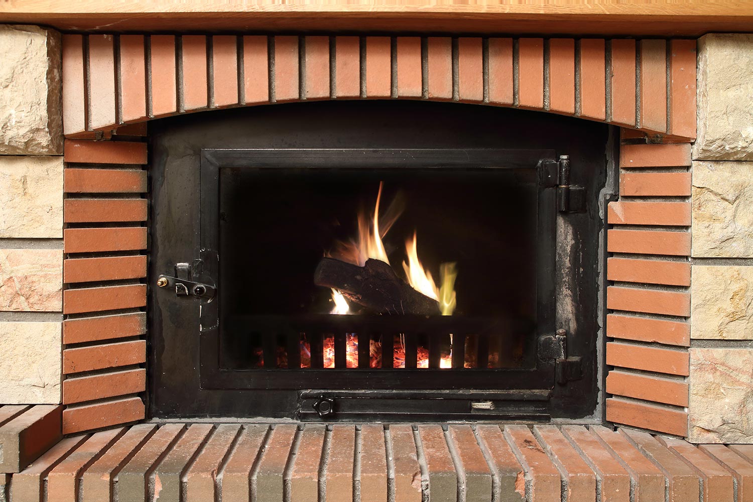 Fire in a brick fireplace in winter