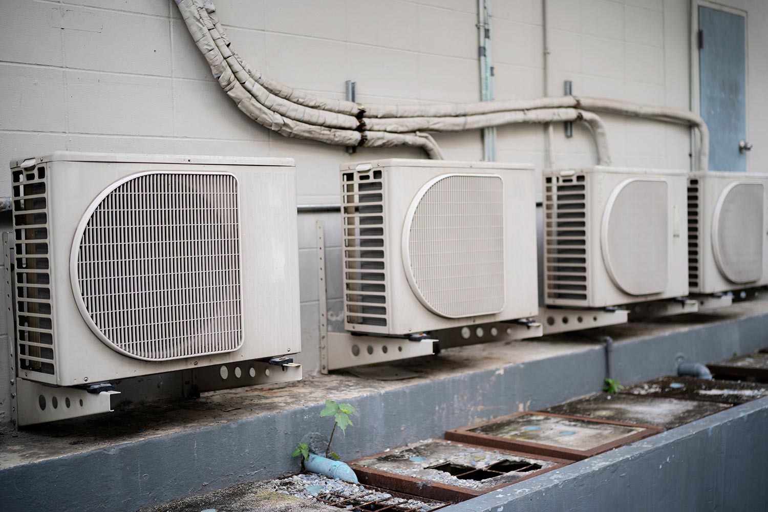Four ductless mini-splits condenser outside of a building