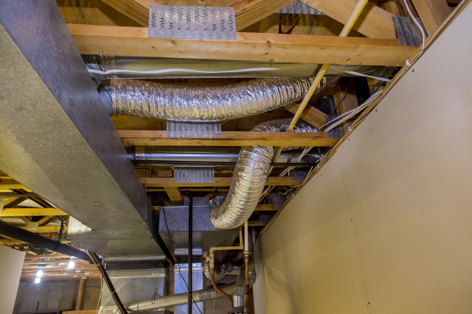 Framed home installation of air conditioner and heating ductwork in ceiling 