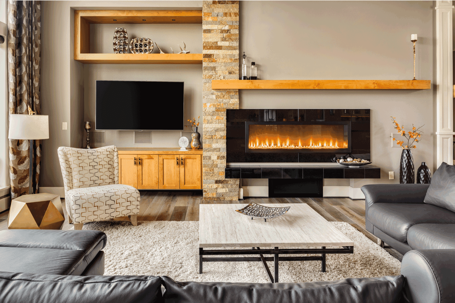 Furnished living Room in Luxury Home with Roaring Fire in Fireplace