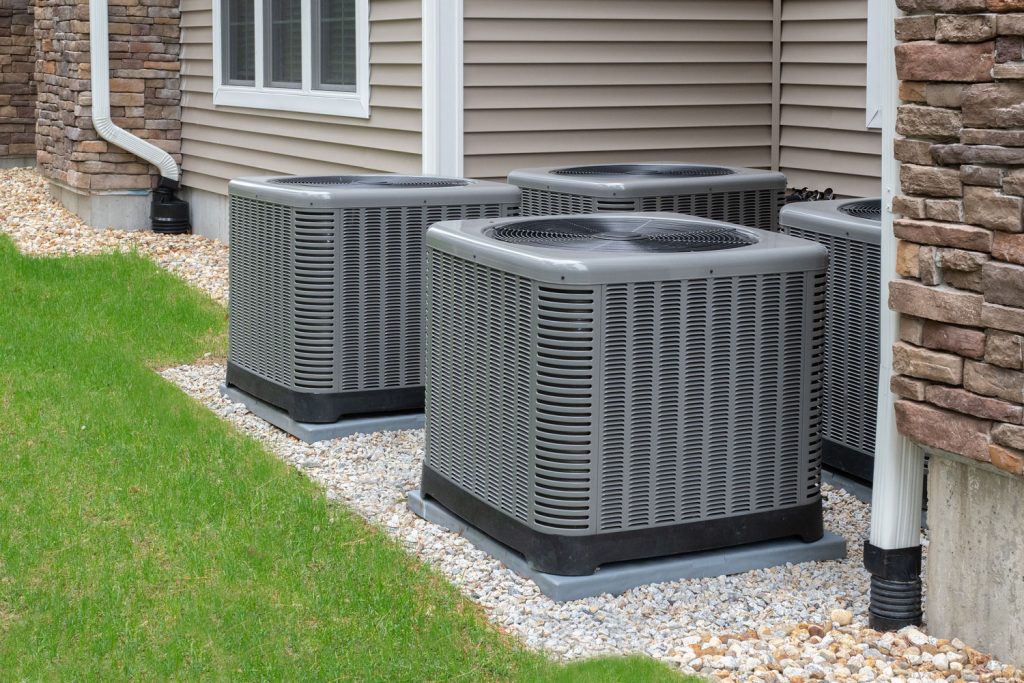 Gray air conditioners for a house with wooden sidings