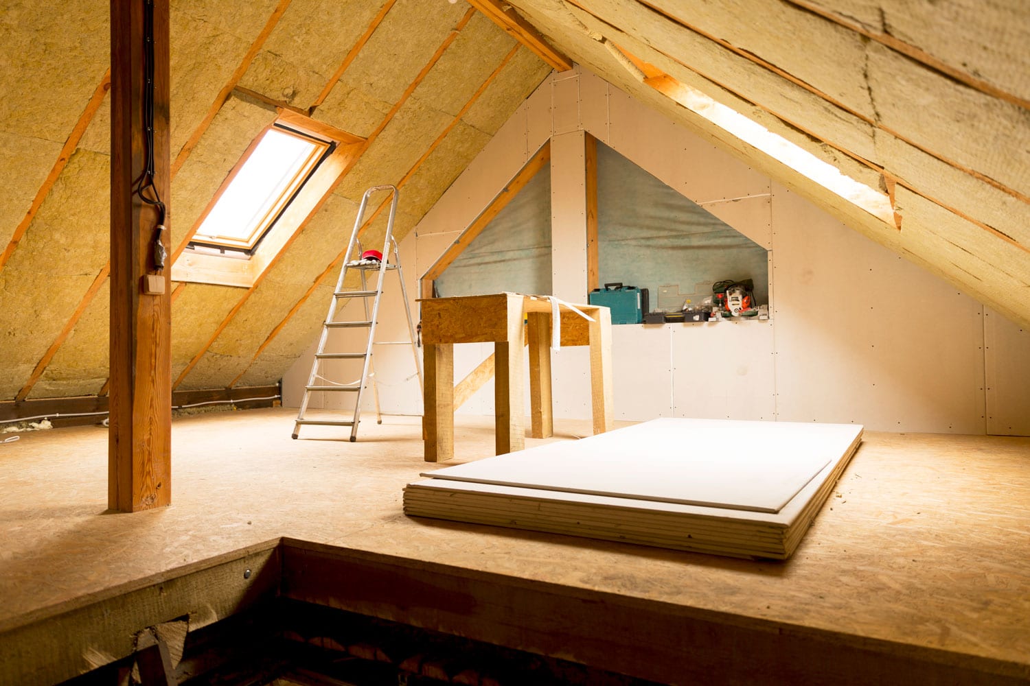 Interior of an attic with fiberglass insulation