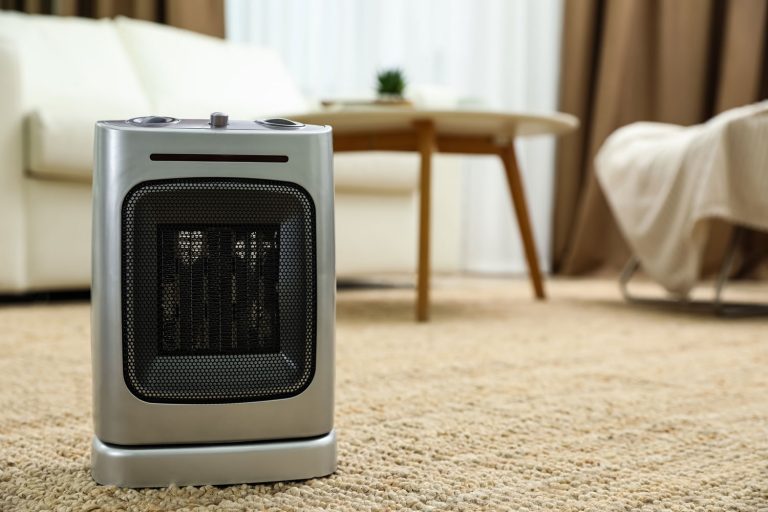 Modern electric fan heater on floor at home, Ceramic Heater Vs. Fan Heater—Which To Choose?