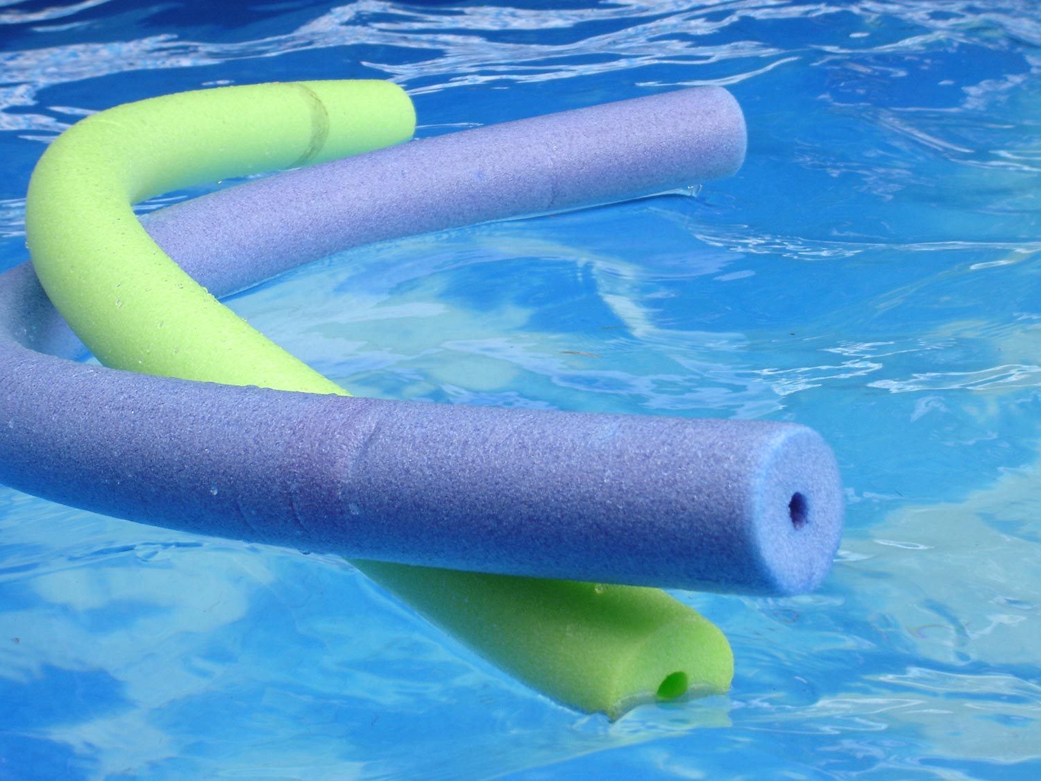 Pool noodles floating on the swimming poll