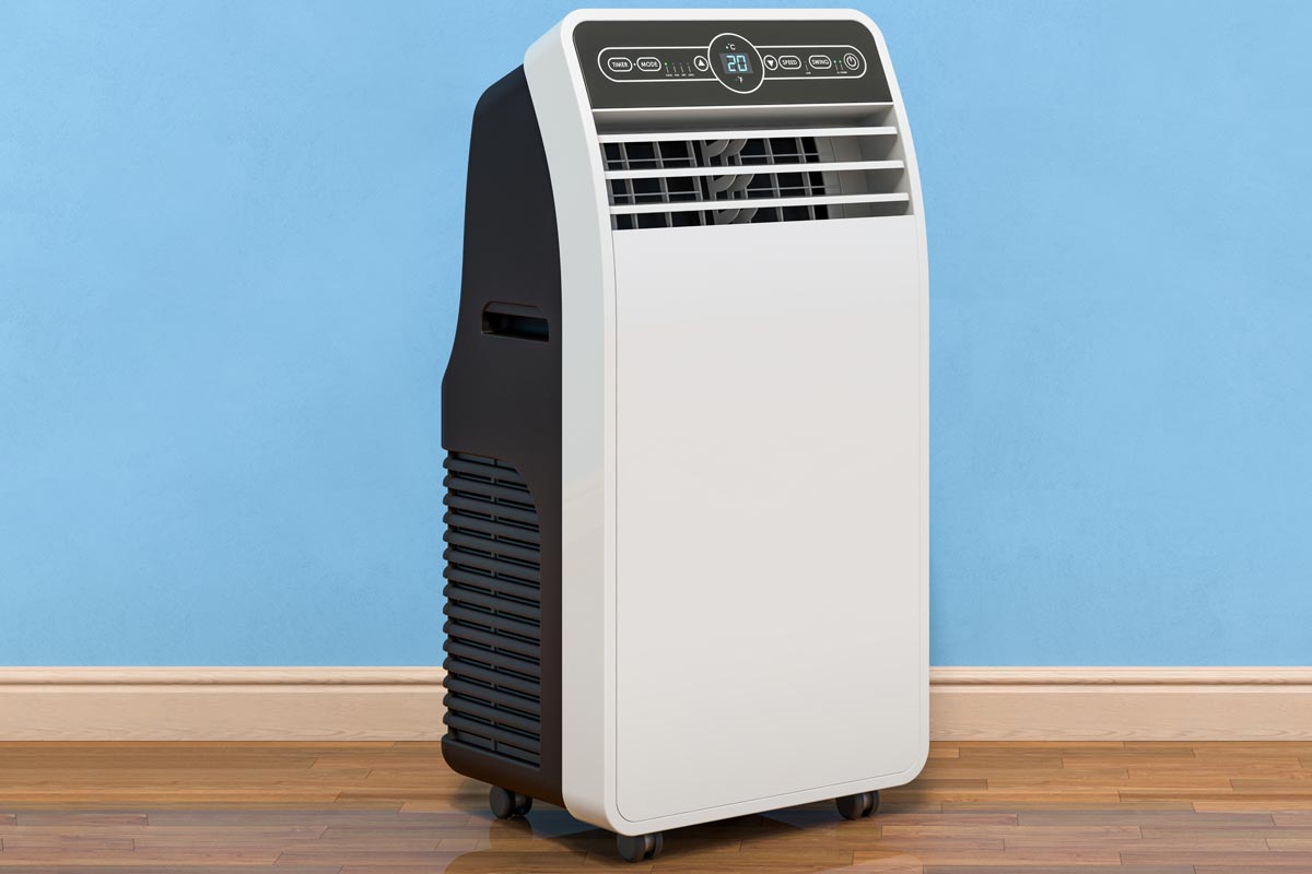 A portable air conditioner in a blue wall room, Should I Drain My Toshiba Portable Air Conditioner? [And How To]