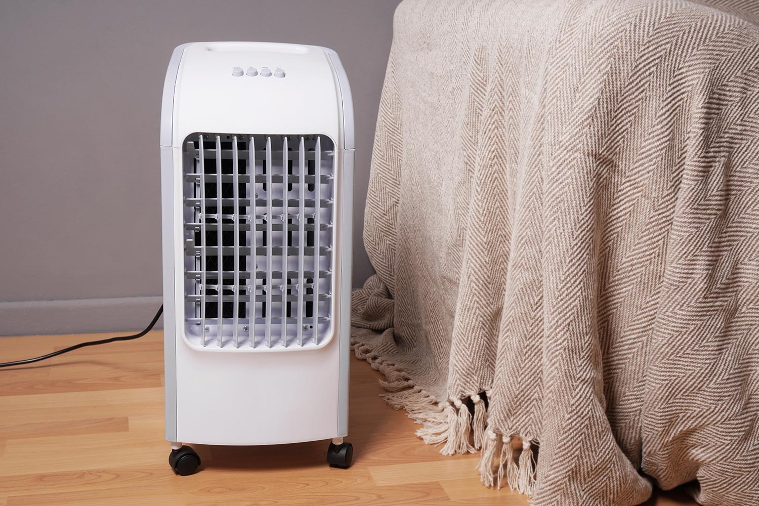 Portable air cooler and humidifier on casters in domestic living room