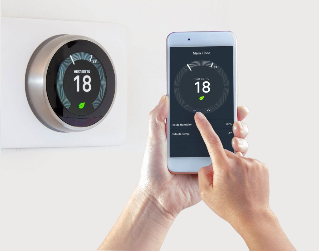 Smart Thermostat with a person saving energy with a smart device on a white background