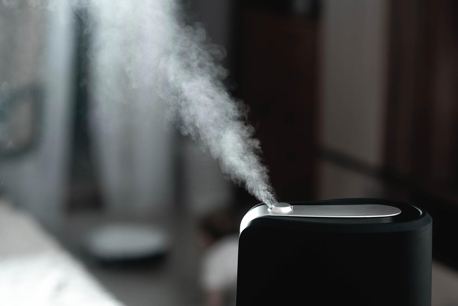 The steam from the humidifier at night in the dark black