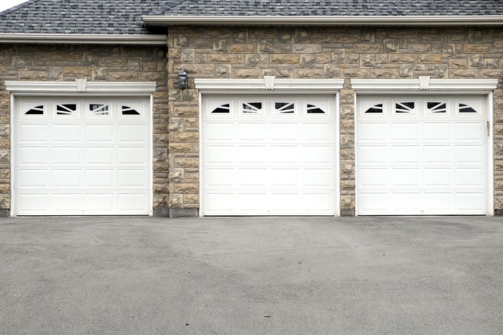 White garage door with decorative stone cladding