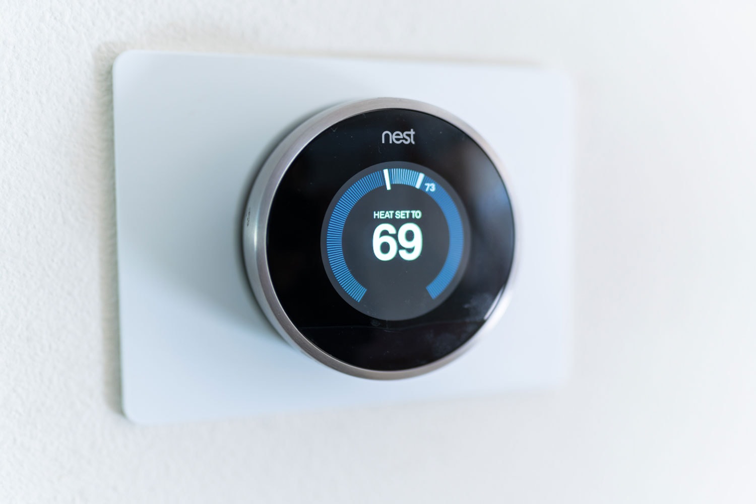 A Nest thermostat set at 69 degrees Fahrenheit