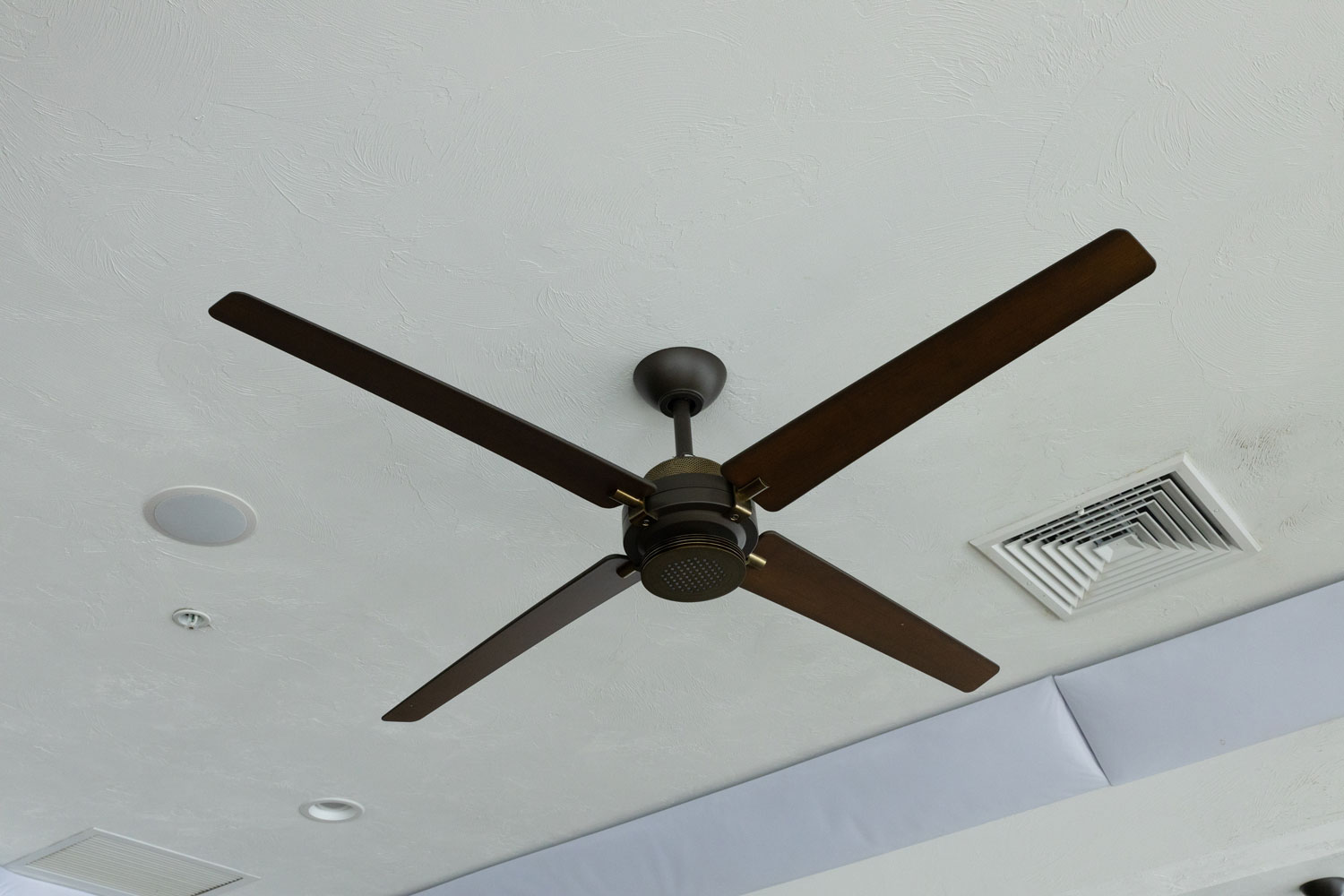 A black ceiling fan with long black blades