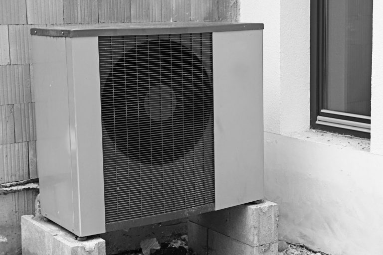 A heat pump placed on top of concrete cinderblocks, How To Pump Down A Heat Pump [ A Step-By-Step Guide]