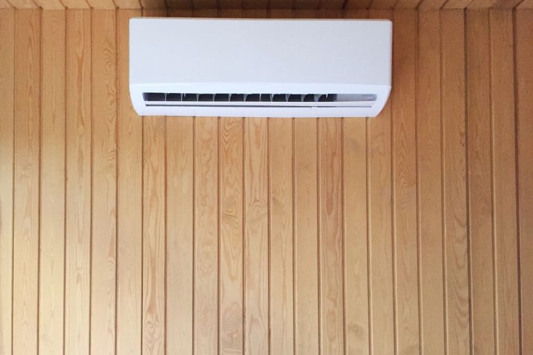 A min split air conditioning unit mounted on the wooden paneling wall, Air Conditioner Delayed Start - Why And How To Fix