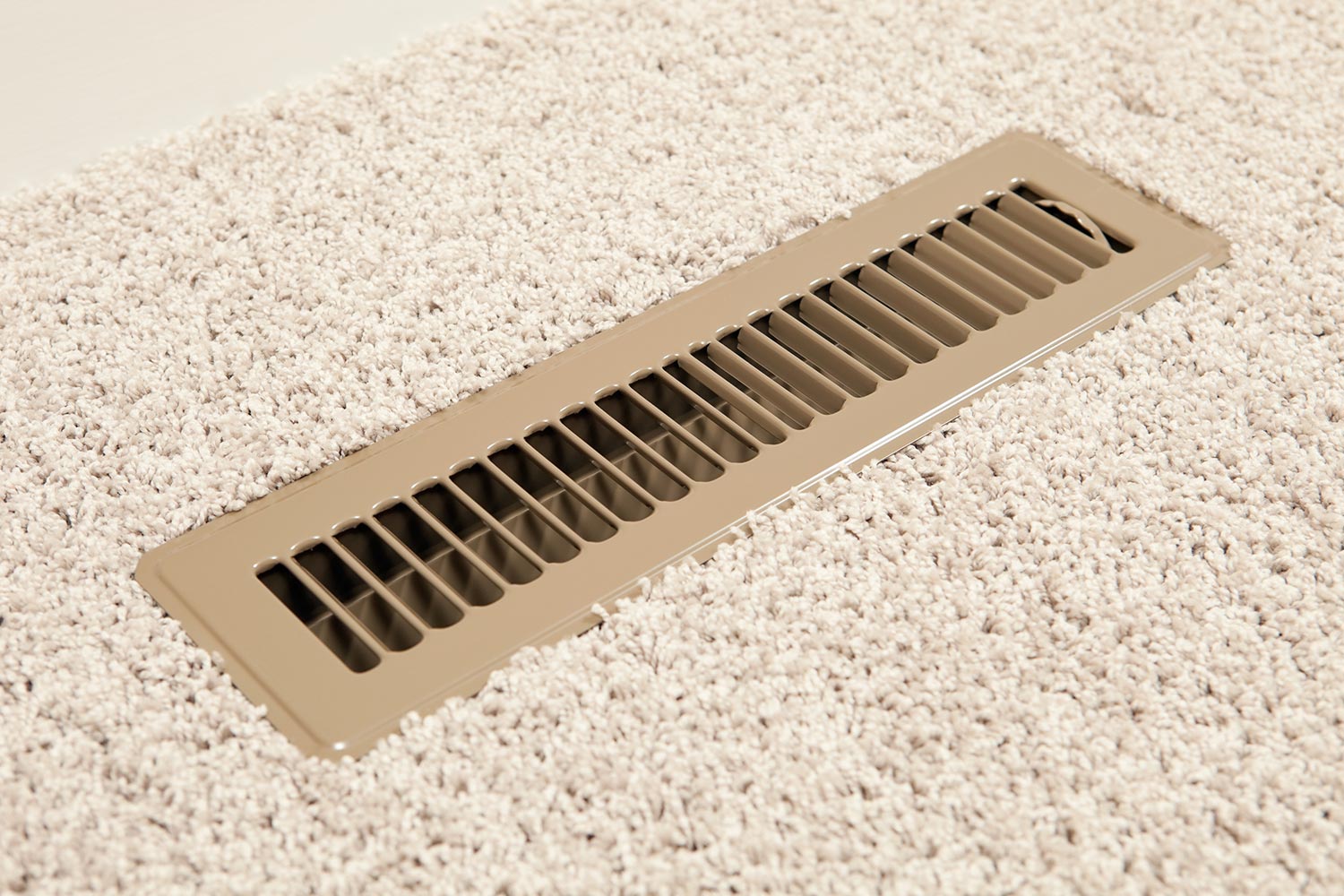 A new metal household adjustable HVAC vent register on a carpeted floor