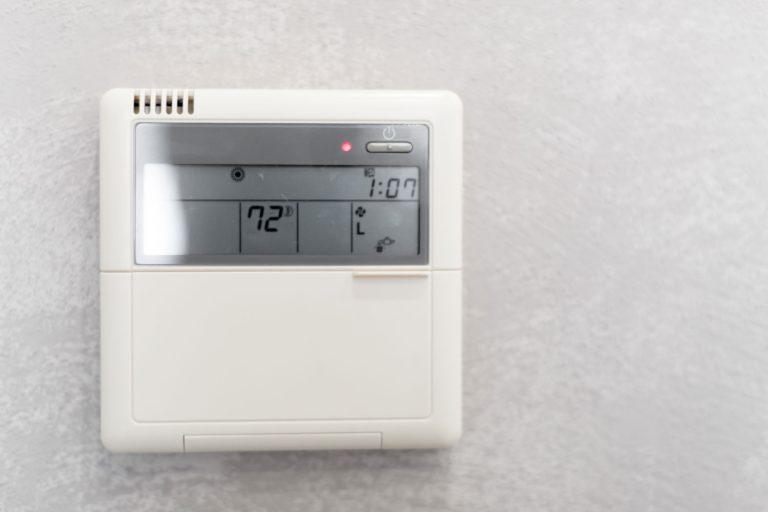 A trane thermostat set to 72 degrees mounted on the wall, How To Reset A Trane AC Thermostat