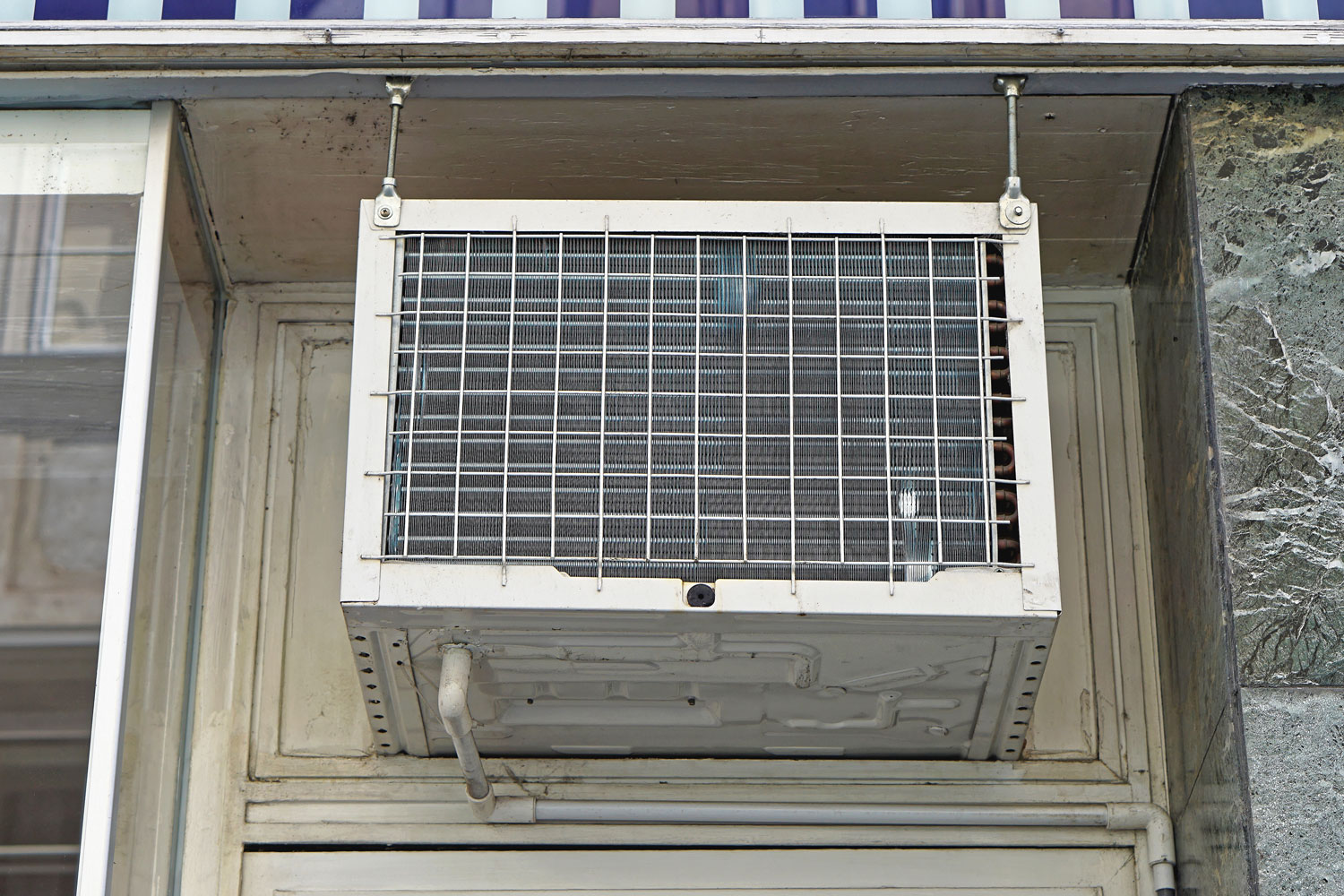A window air conditioner with support brackets installed for an apartment building