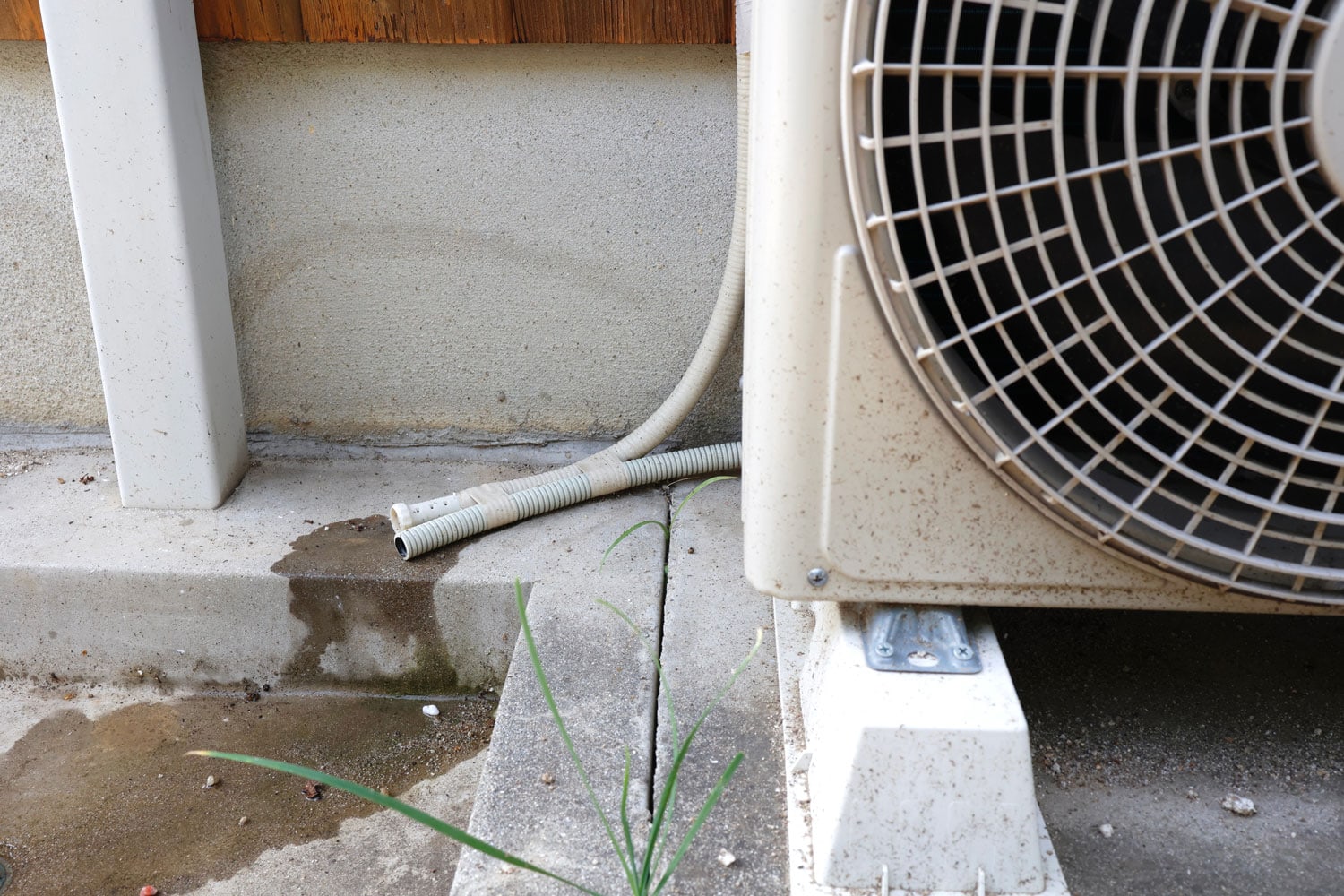 A window air conditioning hose leaking water due to condensation inside the AC