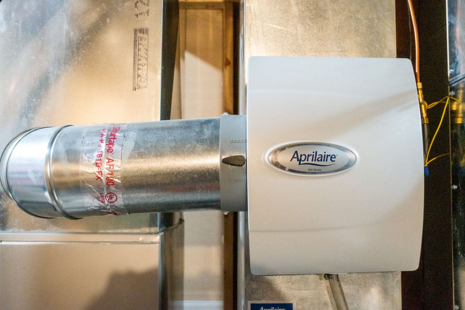 An Aprilaire humidifier mounted on the air duct