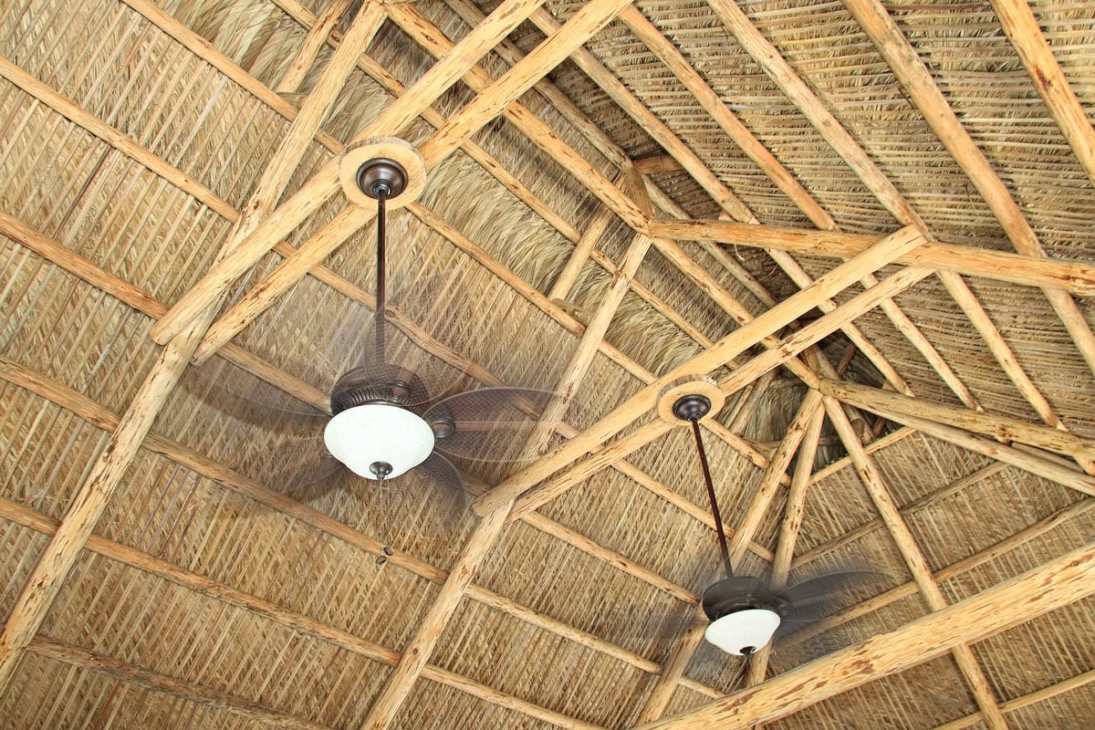 Ceiling fan rafters attached in a hand build tiki hut