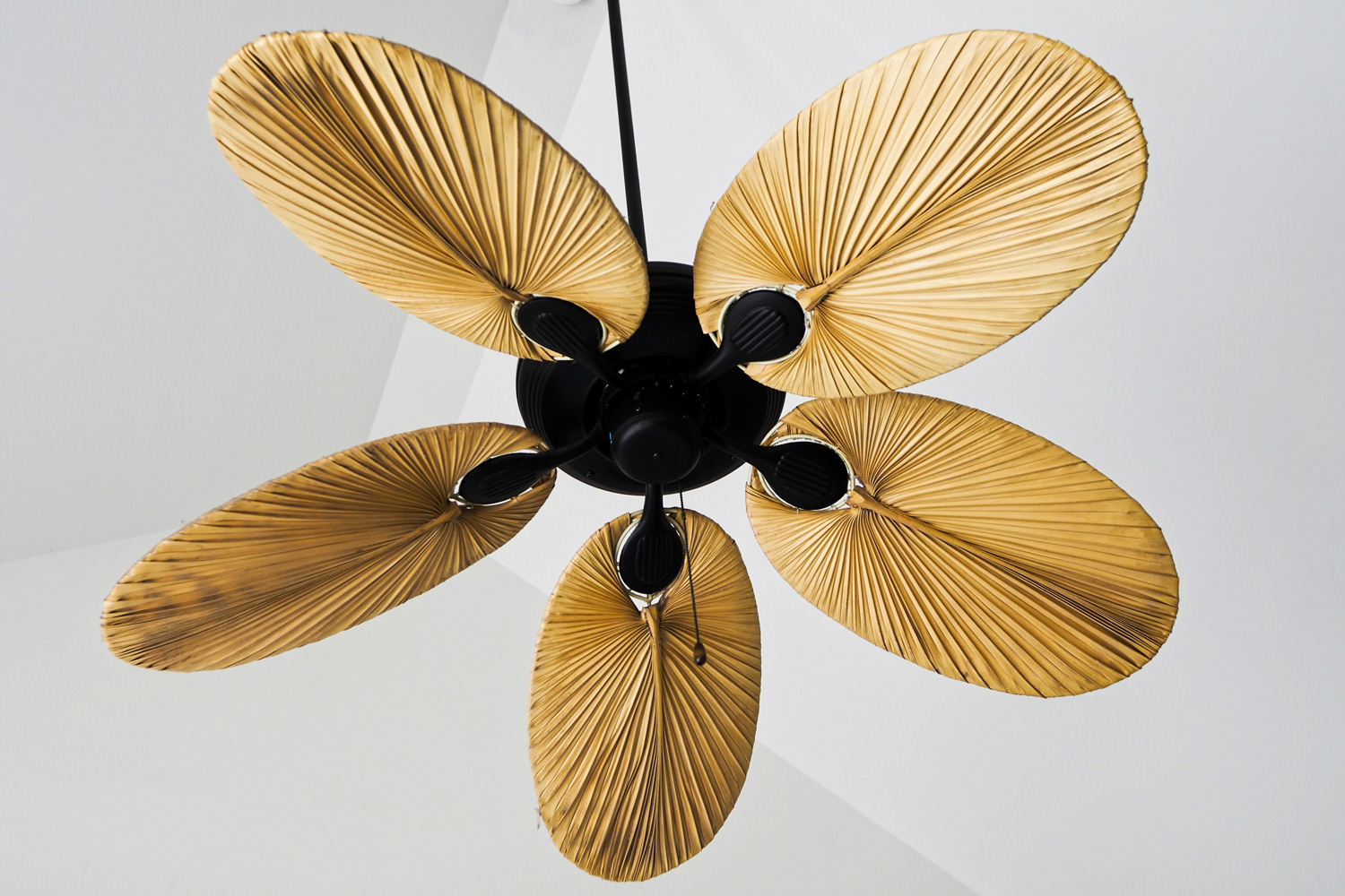 Electric wooden ceiling fan on white background. Interior ideas.