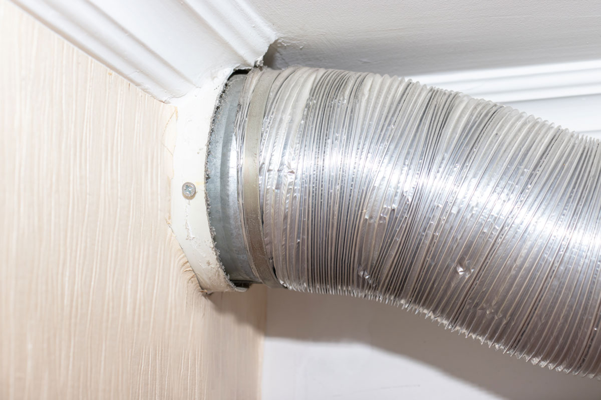 Expandable metallic aluminium corrugated air-conditioning ventilation pipe in kitchen