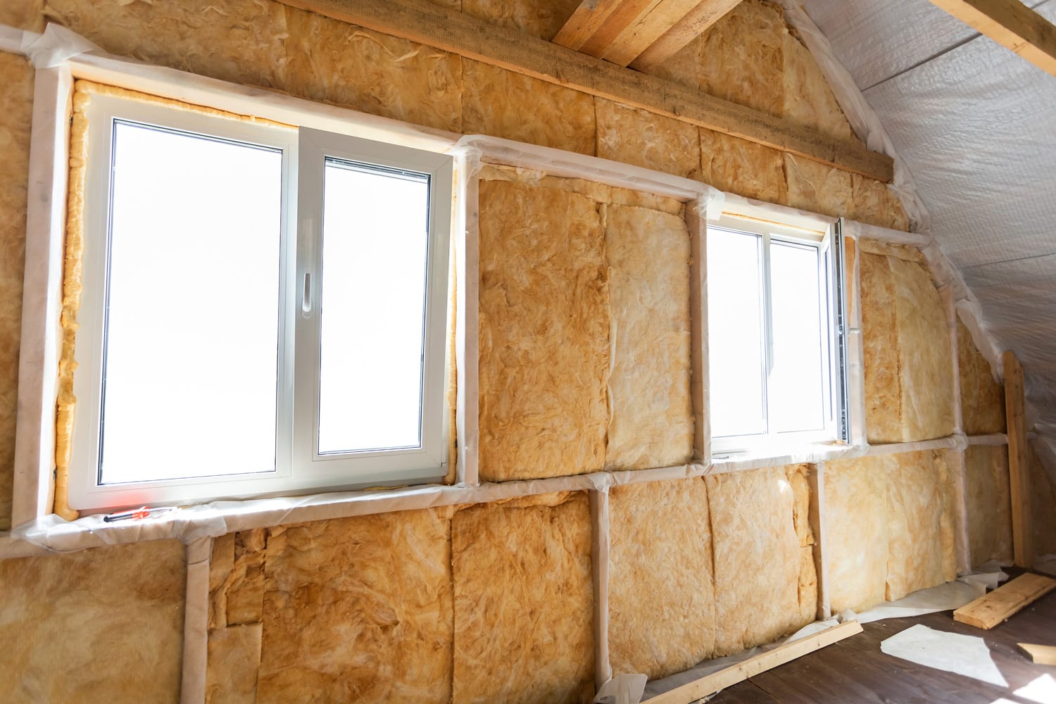Inside wall heat isolation with mineral wool in wooden house, building under construction
