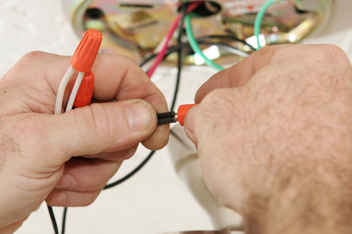 Licensed master electrician connecting wires using a wire nut