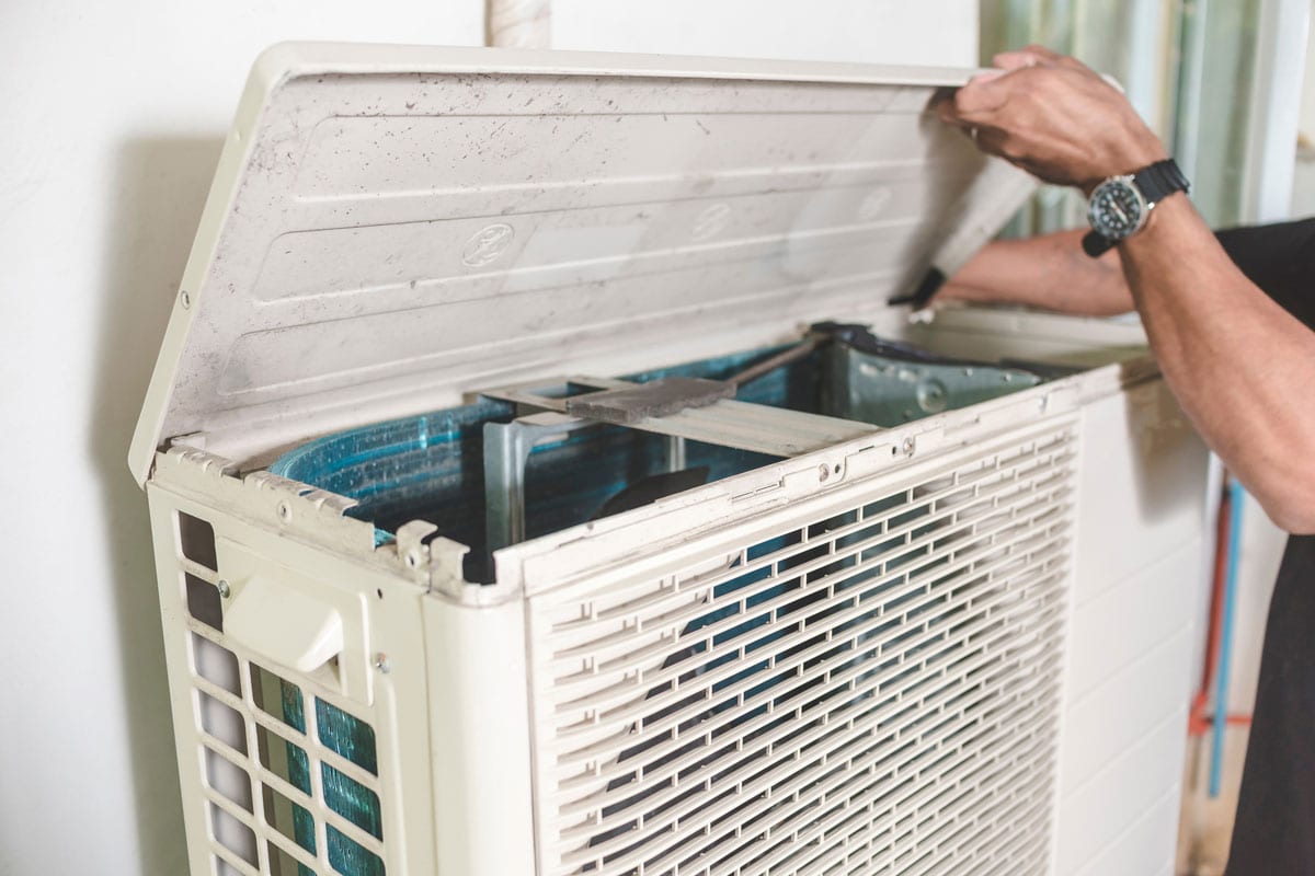 Open up the cover of an outdoor compressor unit of a split type air conditioner