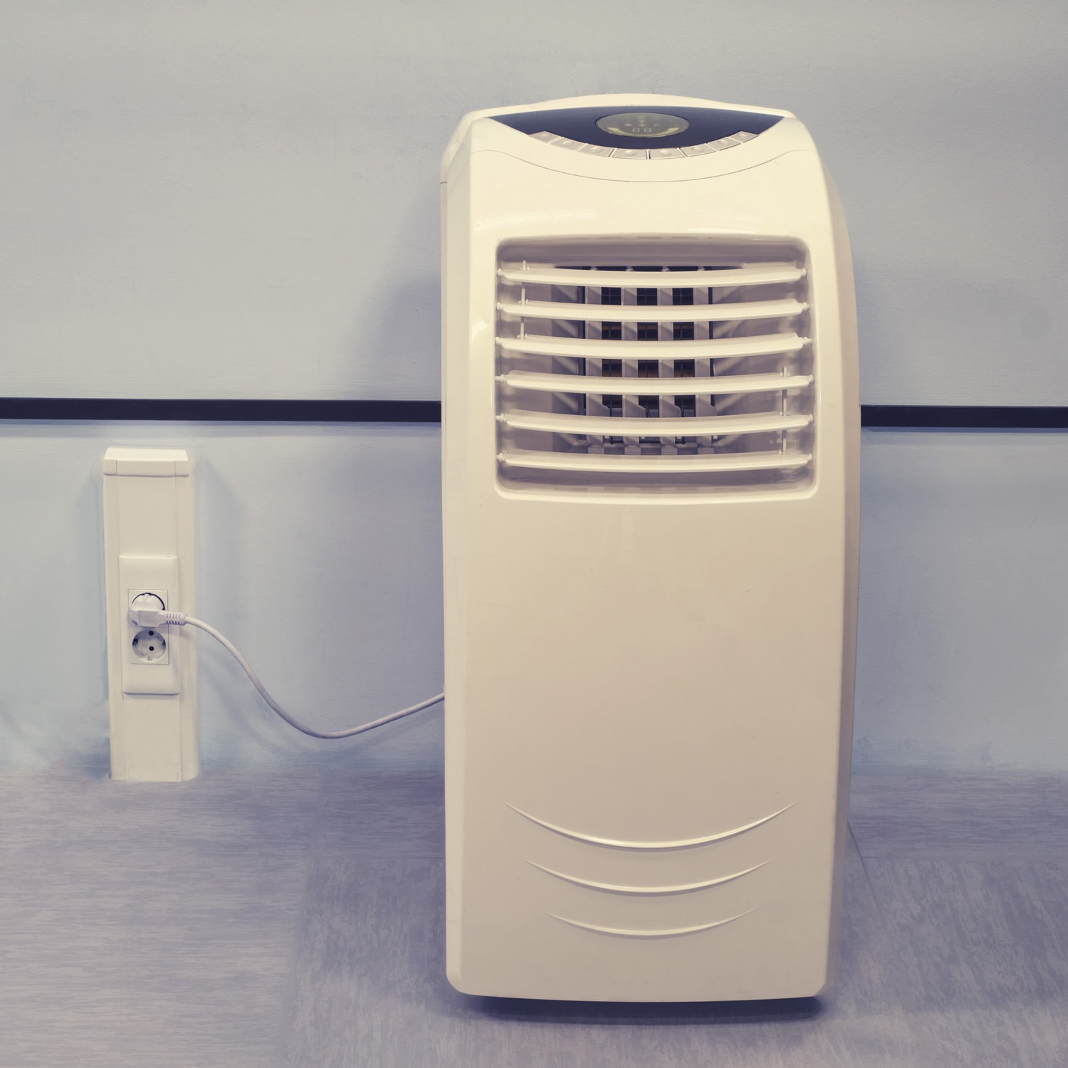 Portable air conditioner in the office connected to an outlet