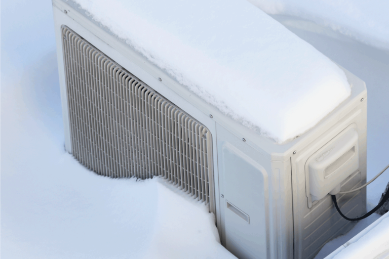 Snow-covered-invertor-Air-conditioner-outdoor-unit-on-roof-top-in-snowdrift-at-winter-day.-Rheem-Air-Conditioner-Making-Loud-Noise-What-To-Do