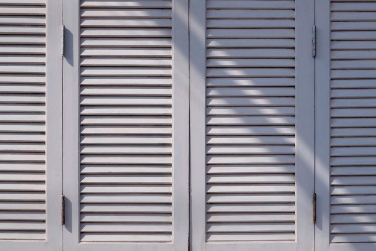 A sunlight and shadow on surface of the old vintage white wooden folding wall, HVAC Closet Door Tips And Ideas