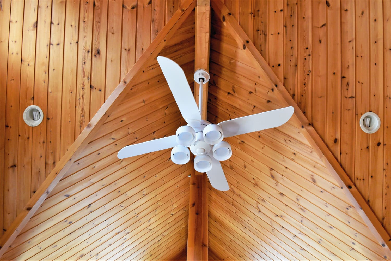 Ventilation fan on wooden ceiling.