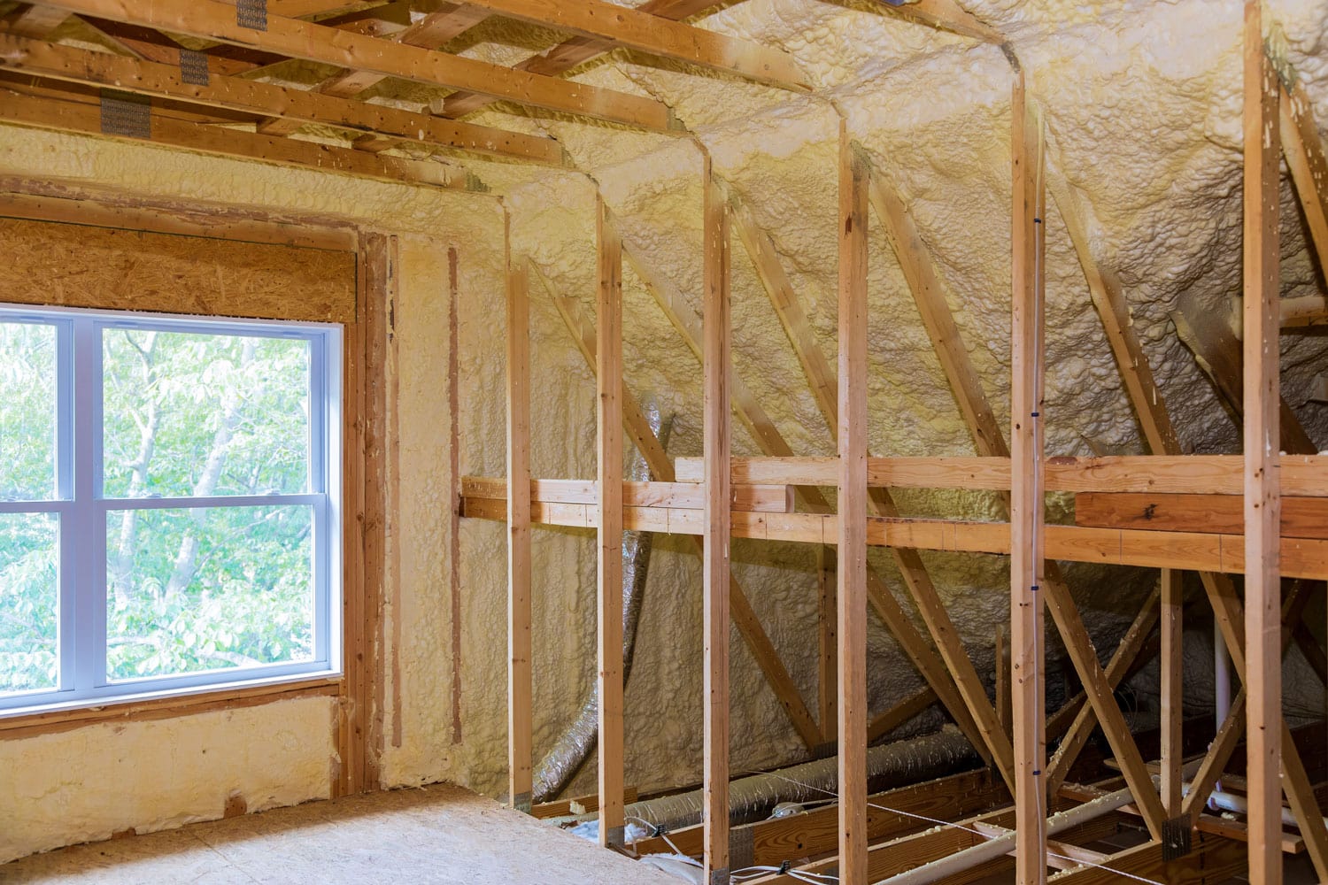 Wooden framing of a house with spray foam insulation, What Insulation To Use For 2X6 And 2X4 Walls