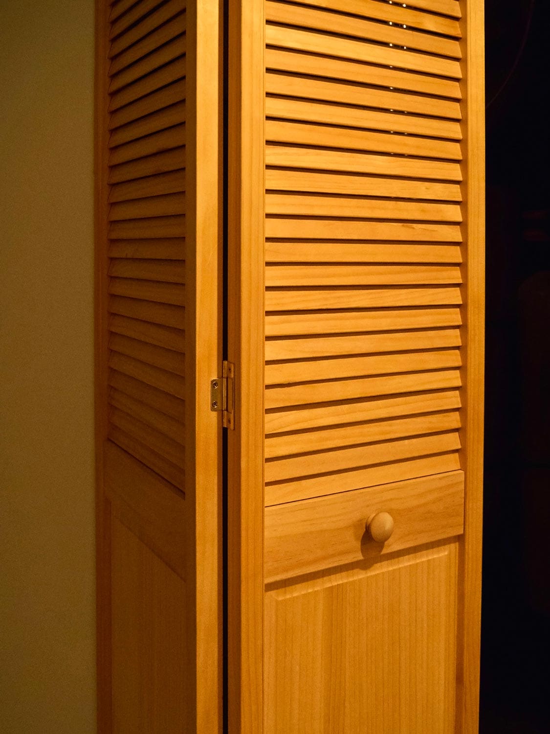 Yellow bi-fold utility door with door knob