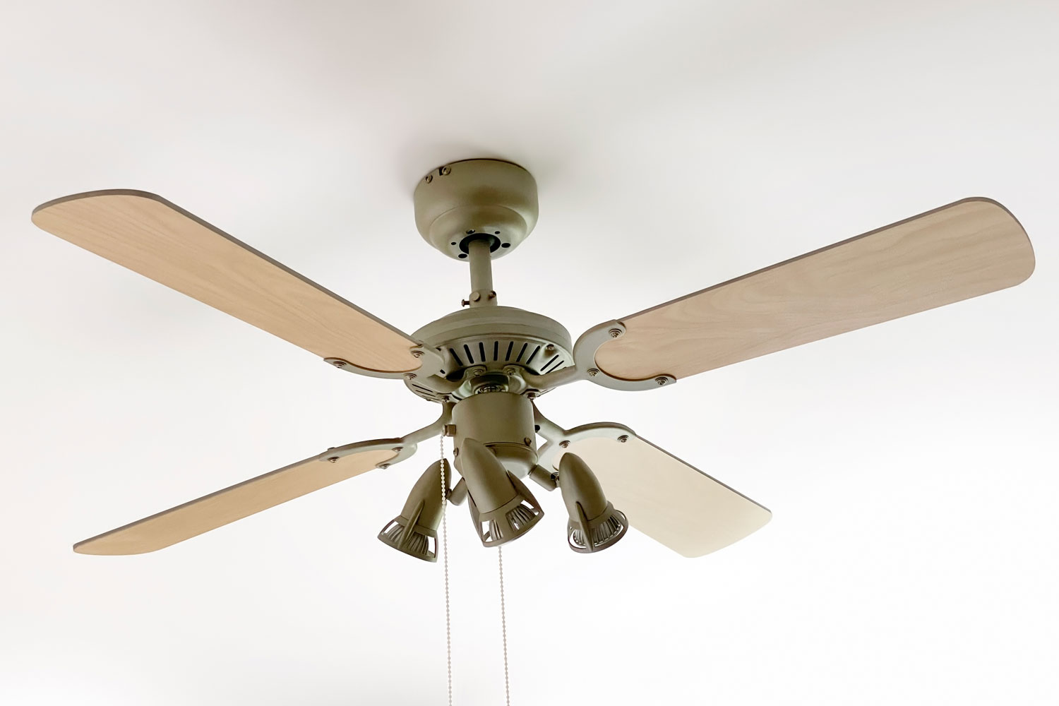 A classic brown and dark green painted ceiling fan