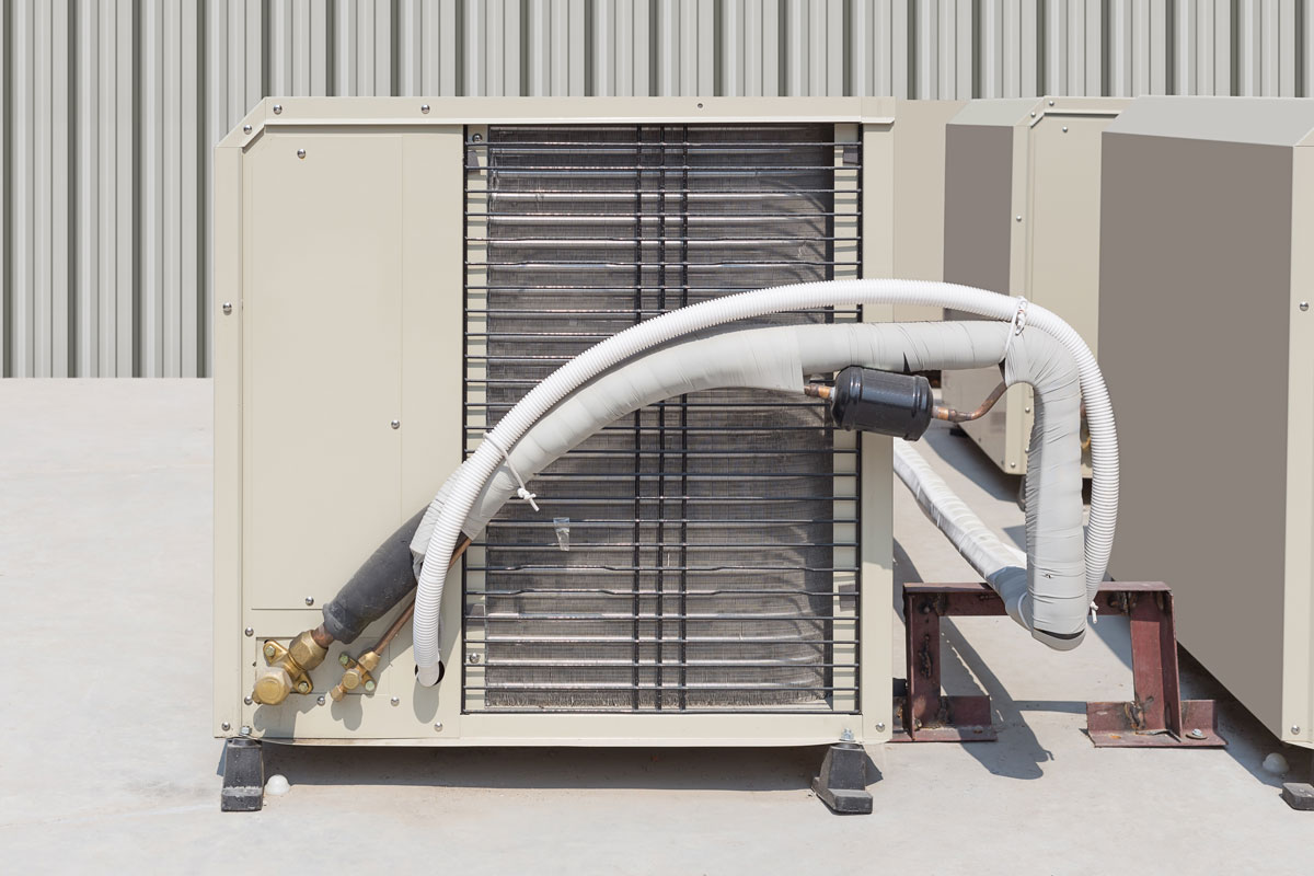 Air condenser with its exposed drain line pipe
