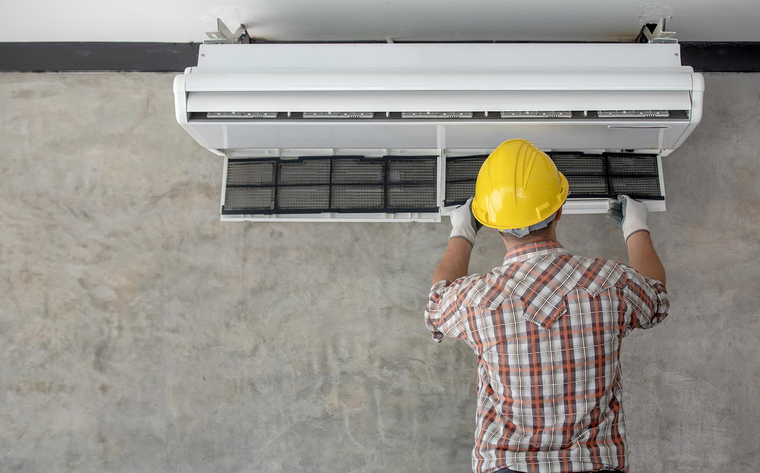 Air conditioning technician repairing air conditioner and install new air conditioner