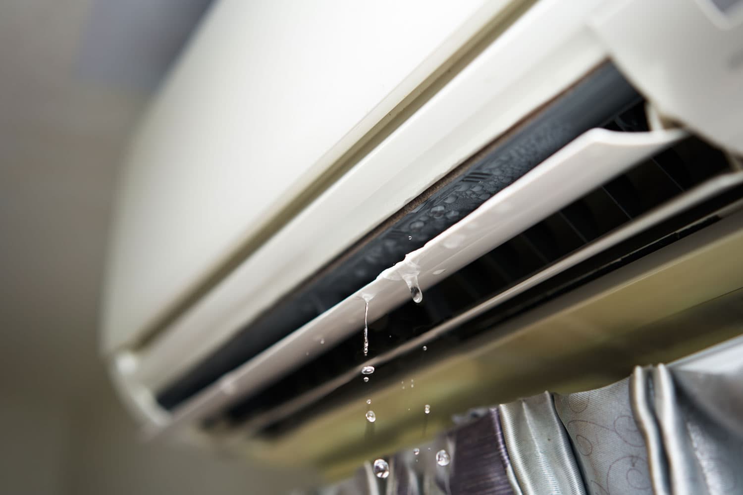 An AC unit dripping water due to high humidity