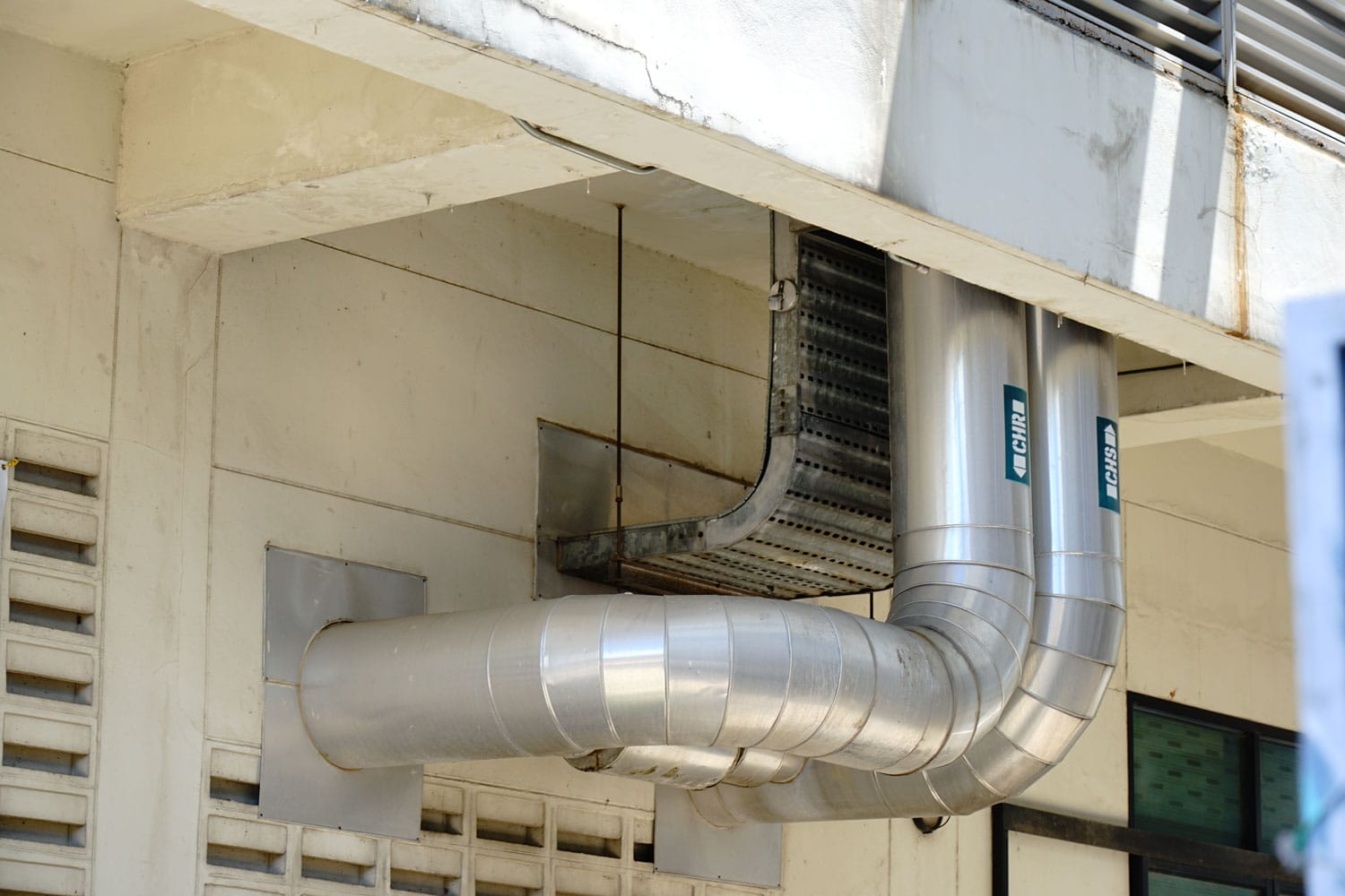 An air conditioning unit exhaust photographed outside a building