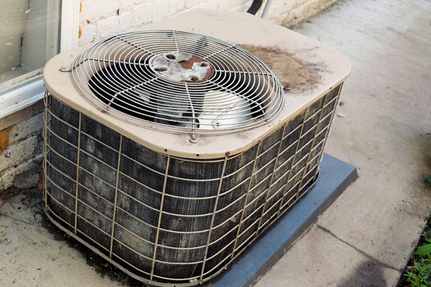 An old and dirty air conditioning unit needed for cleaning