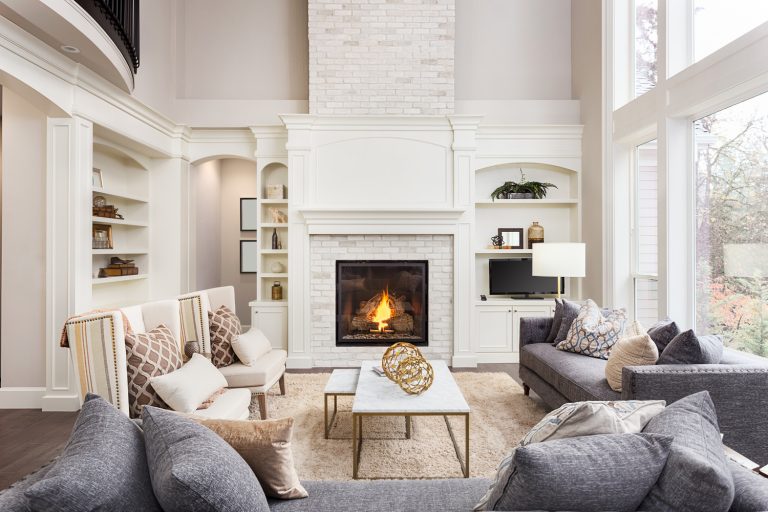 Beautiful living room interior with hardwood floors and fireplace in new luxury home. Large bank of windows hints at exterior view - Can You Open Up A Fireplace On Both Sides
