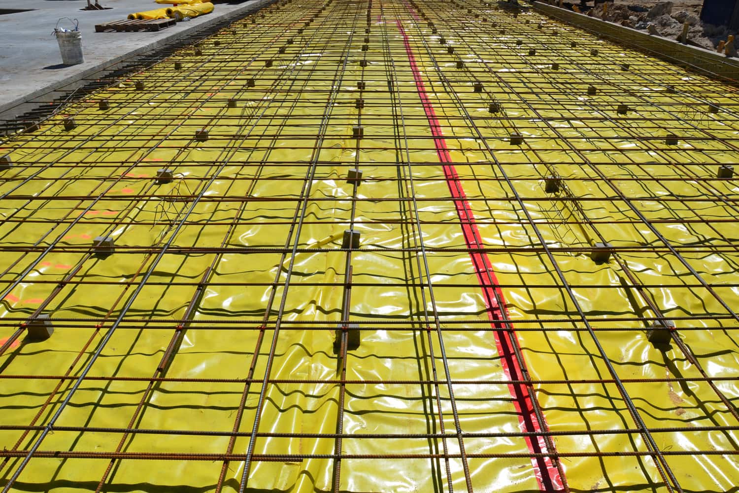 Concrete pour with reinforcing and yellow vapor barrier